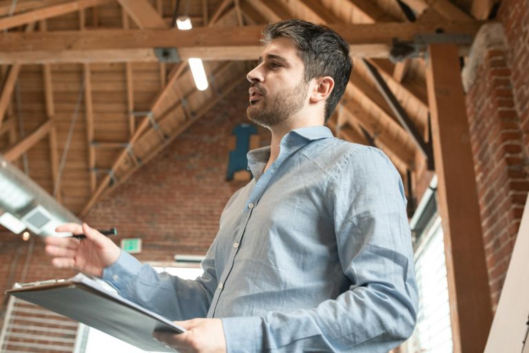 bearded handsome man holding a clipboard